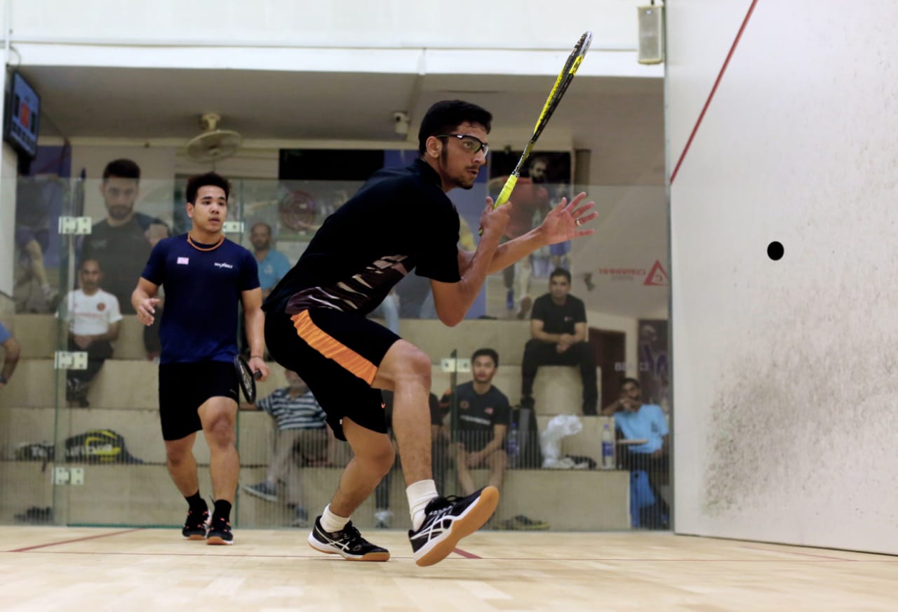 Muhammad Ammad and Wee Ming Hock on court during their first round match in Islamabad