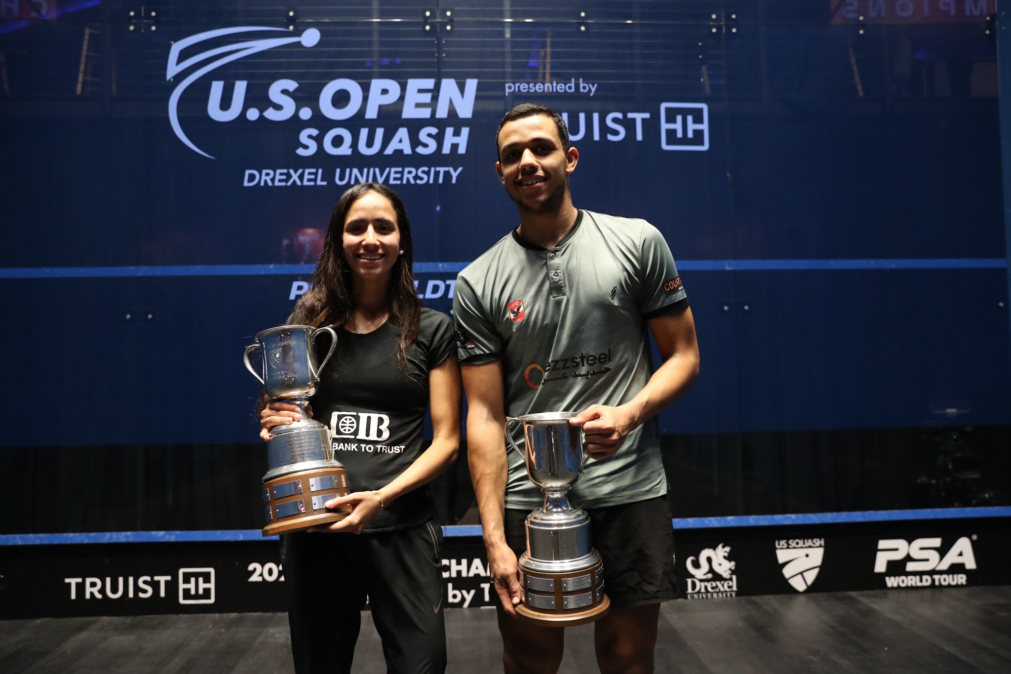 Mostafa Asal and Nouran Gohar with the U.S. Open trophies